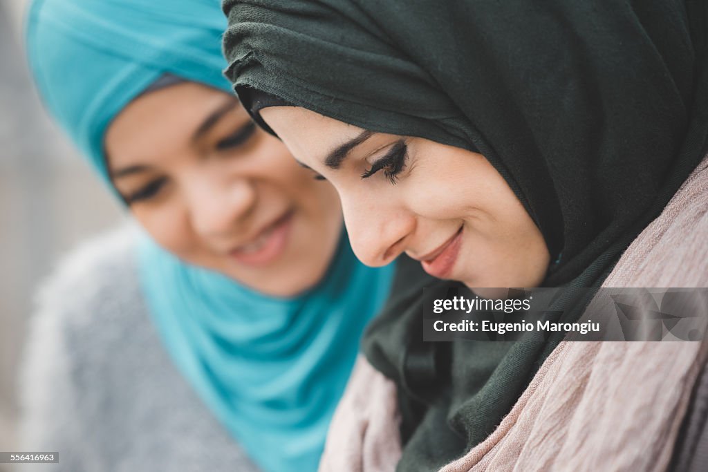 Close up of two young women wearing hijabs