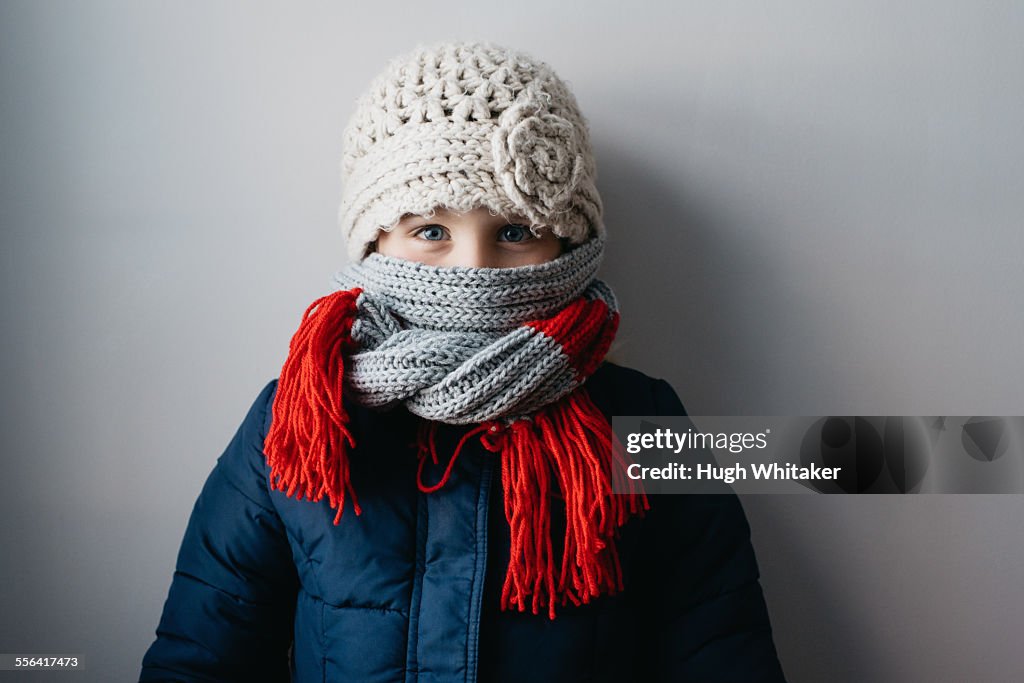 Girl warmly wrapped up in woollen hat and scarf