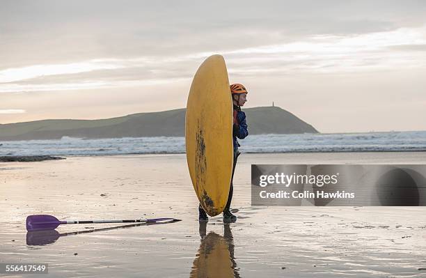 young woman on beach with sea kayak, polzeath, cornwall, england - polzeath bildbanksfoton och bilder