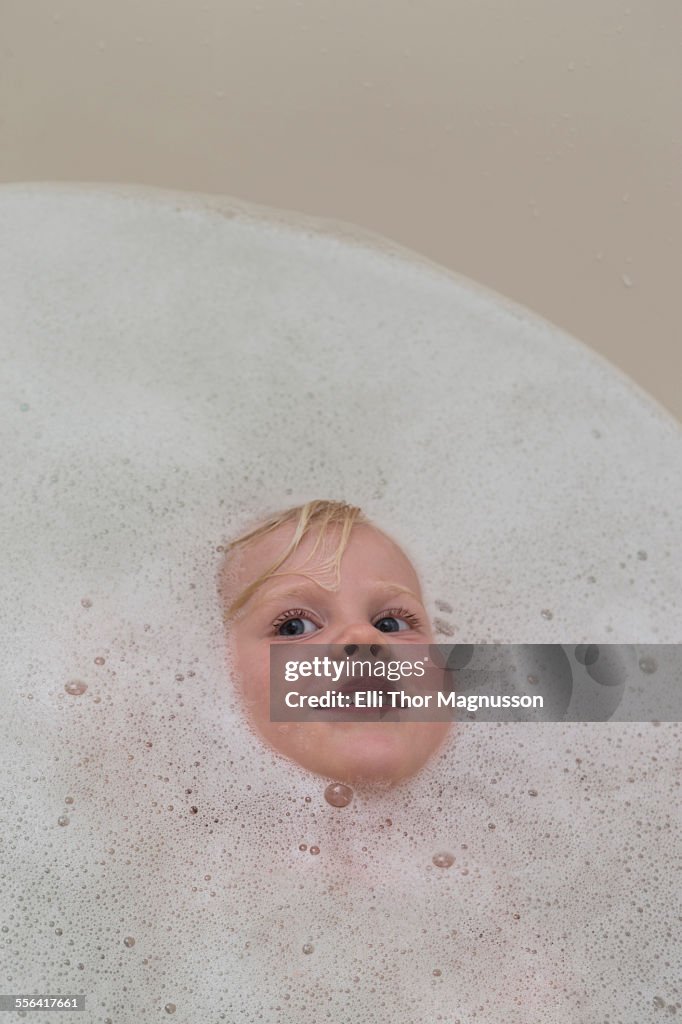 Portrait of angelic female toddlers face in bubble bath