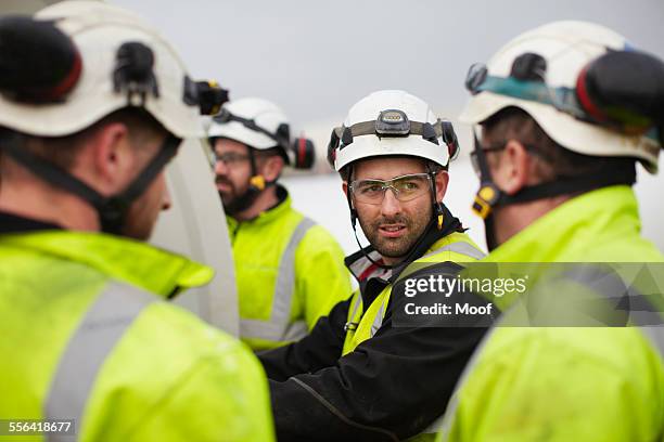 engineers working on wind turbine - sports helmet stock pictures, royalty-free photos & images