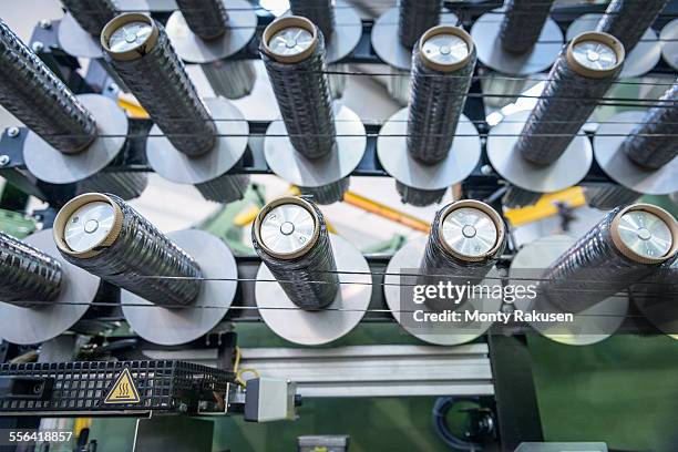 rows of carbon fibre on loom in carbon fibre factory, close up - tear imagens e fotografias de stock