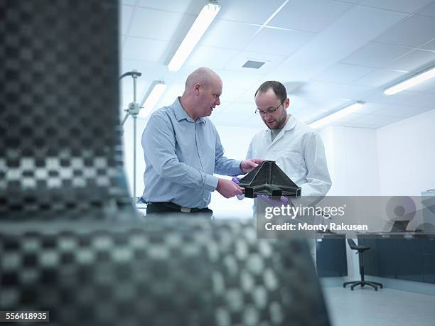 scientists inspect carbon fibre part in carbon fibre laboratory - carbon fiber stock pictures, royalty-free photos & images