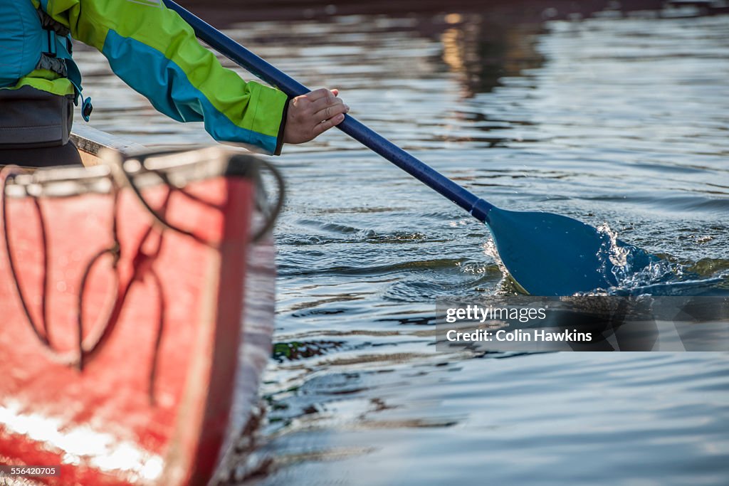 Woman steering canoe