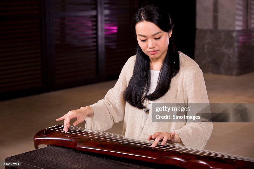 Young Woman Playing the Guqin