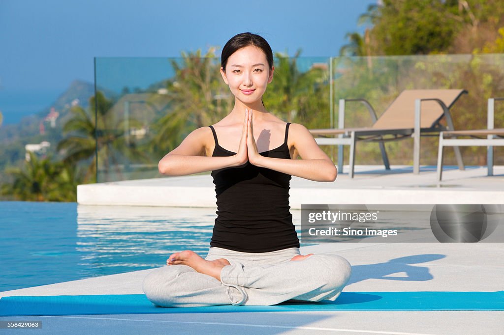 Young Woman Doing Yoga at Seaside