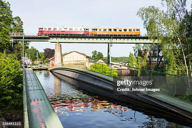 canal, train on bridge - dalsland stock-fotos und bilder