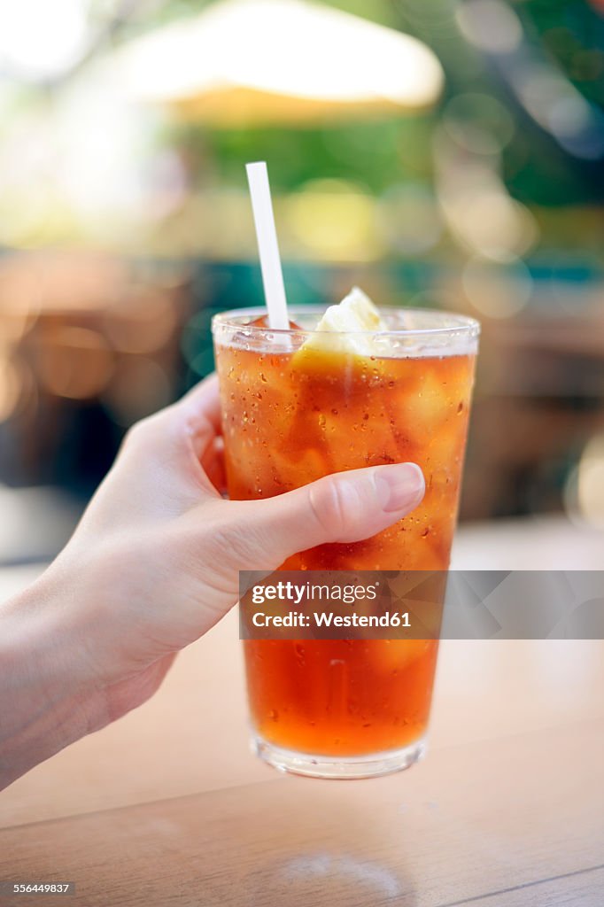 USA, Hawaii, Maui, hand holding iced tea with lemon