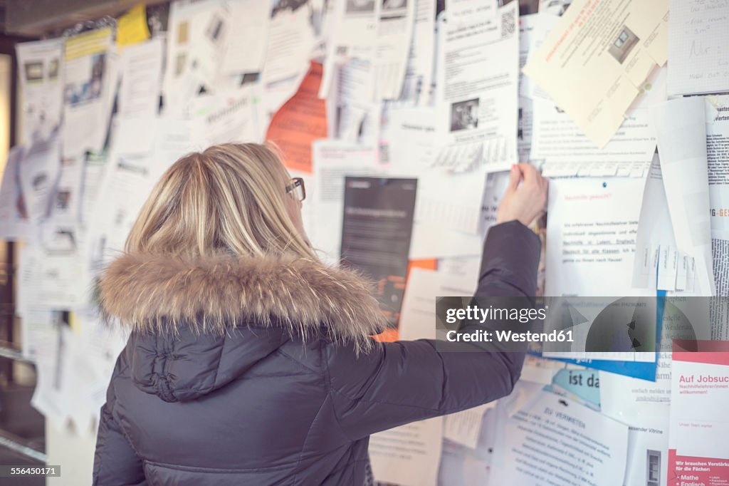 Woman reading at notice board
