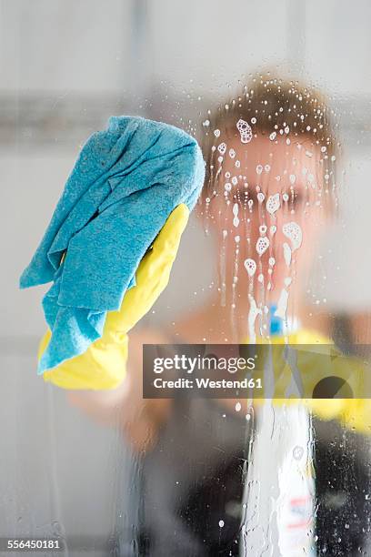 woman cleaning glass pane - bath shower stock pictures, royalty-free photos & images