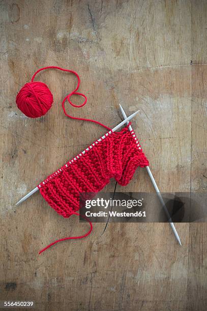 red ball of wool and knitting on wood - ball of wool ストックフォトと画像