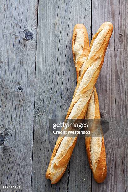 two french baguettes on grey wood - barra de pan francés fotografías e imágenes de stock