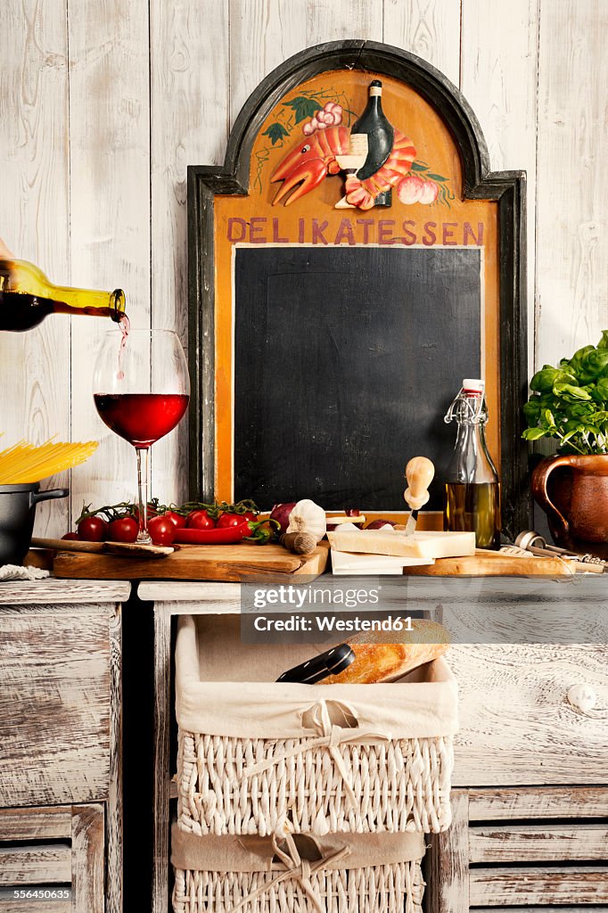 Italian Food, sideboard with typical ingredients, spaghetti, tomato, red wine