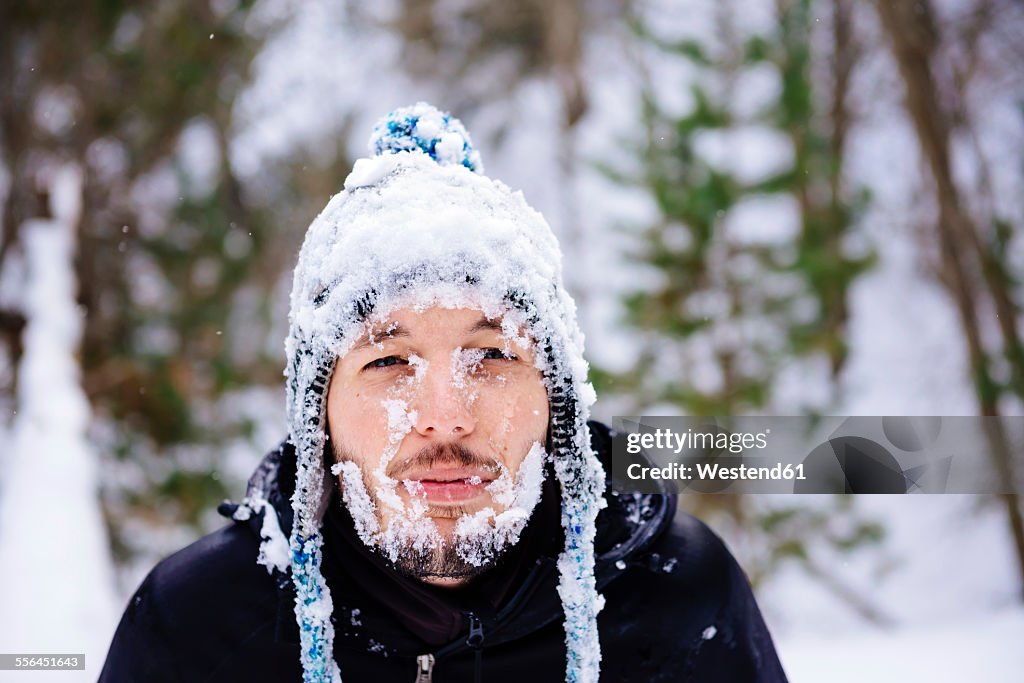 Man covered with snow in the forest