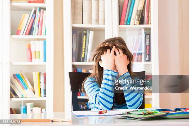 frustrated girl doing homework - young girls homework stock-fotos und bilder