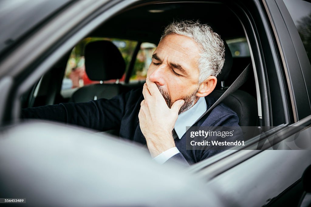 Tired man driving car