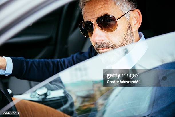 man with sunglasses driving car - cool cars ストックフォトと画像