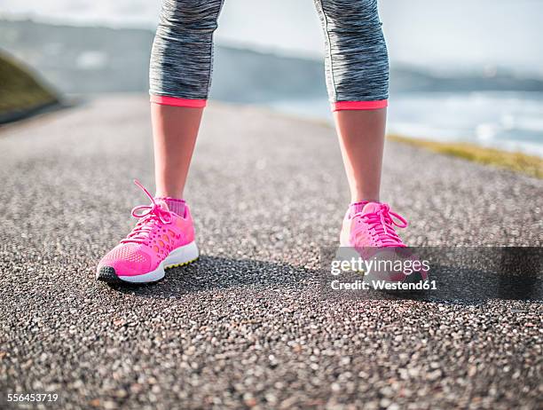 spain, gijon, legs of sportive young woman on path - sports shoe close up stock pictures, royalty-free photos & images