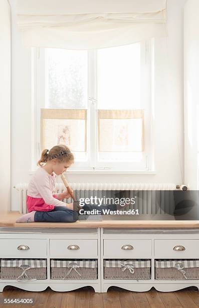 little girl playing recorder at home - flauto foto e immagini stock