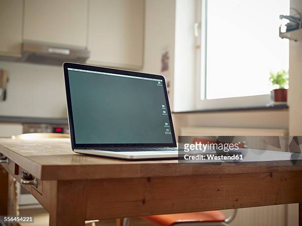 laptop on kitchen table - laptop table stock pictures, royalty-free photos & images