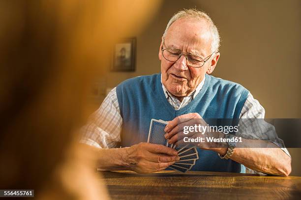 senior man playing cards - senior men playing cards stock pictures, royalty-free photos & images