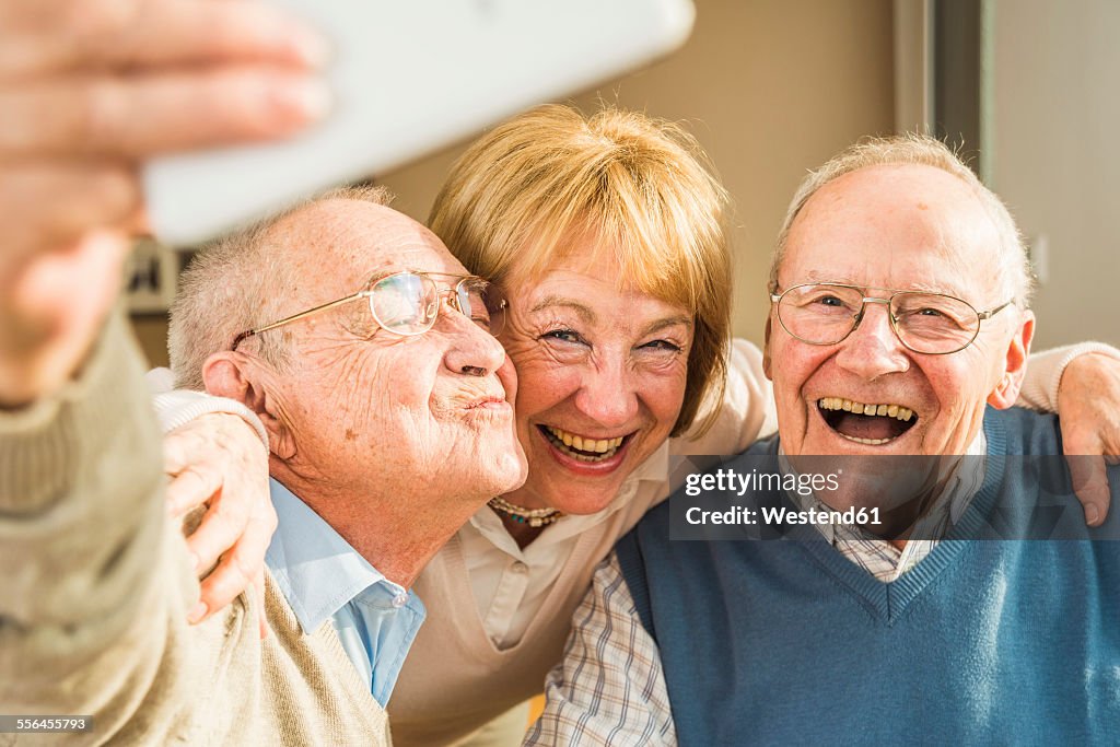 Cheerful seniors taking selfie