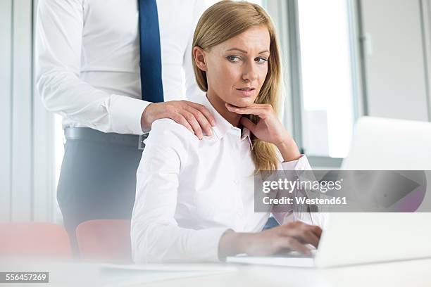 colleague harassing businesswoman - harassment man woman office stock-fotos und bilder