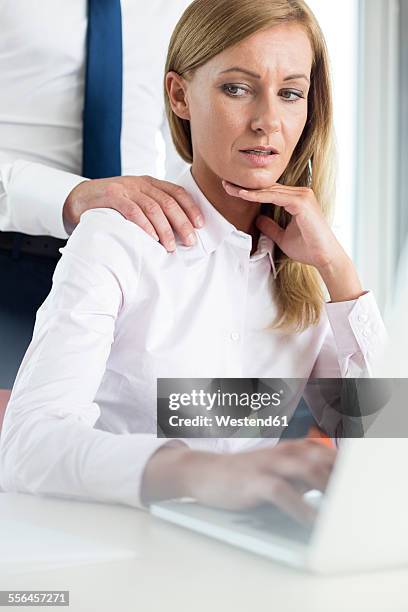 colleague harassing businesswoman - sexual harassment stock pictures, royalty-free photos & images