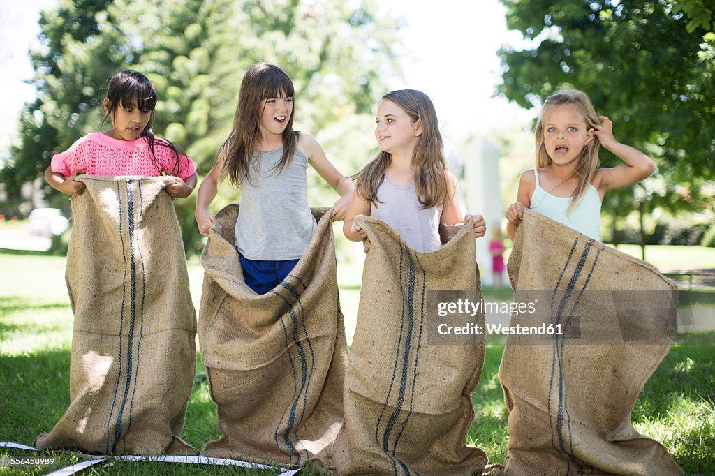 Girls competing in a sack race