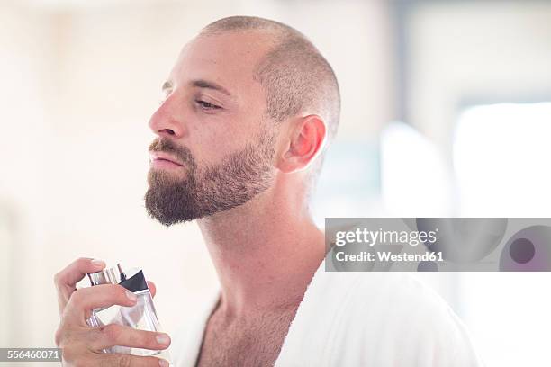 man using eau de cologne - man spraying stock pictures, royalty-free photos & images