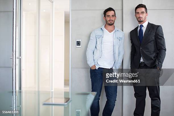 casually and formally dressed twin males in office - twin bildbanksfoton och bilder