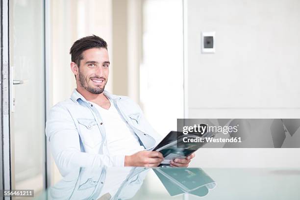 portrait of casually dressed man in office - glass magazine stock pictures, royalty-free photos & images