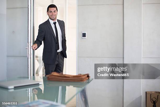 businessman in suit opening boardroom door - entering door stock pictures, royalty-free photos & images