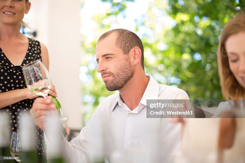 Man examining white wine on a wine tasting session