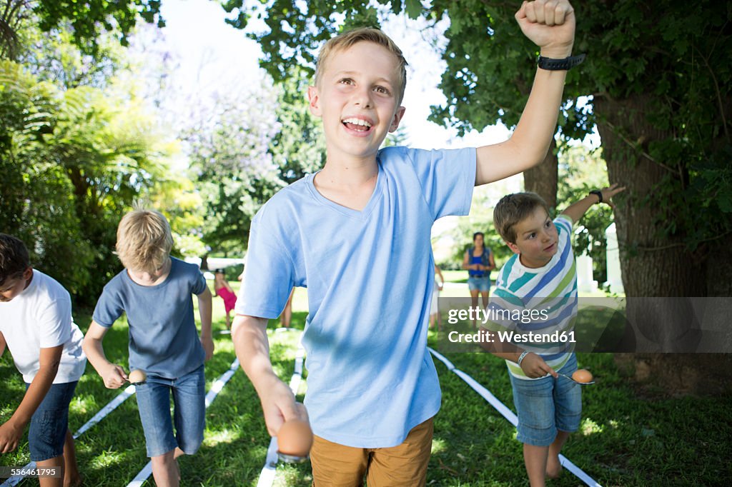 Boy winning in an egg-and-spoon race