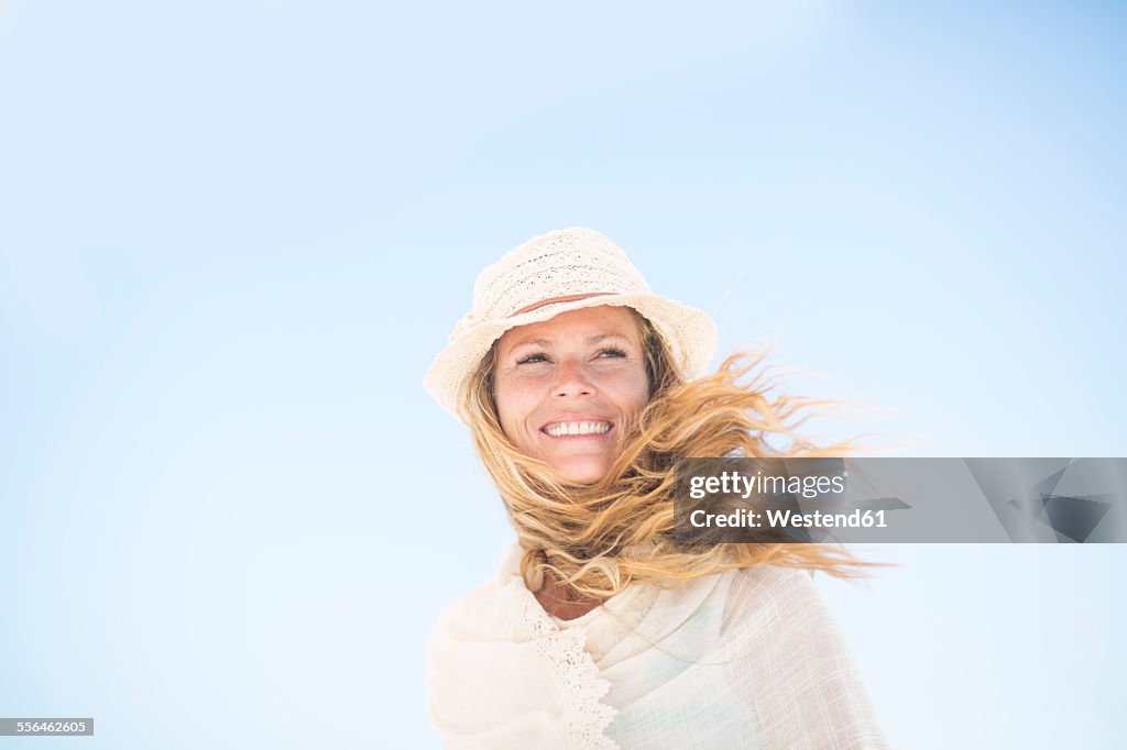 Smiling woman under blue sky