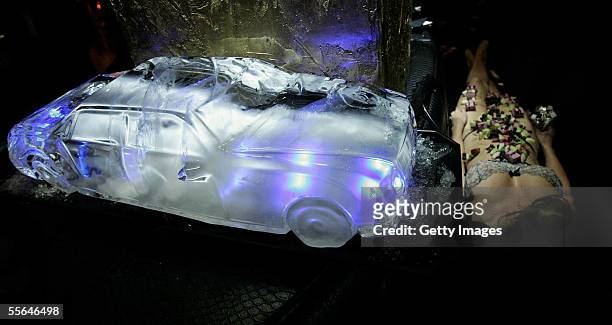 An ice sculpture of a Maybach is seen next to a semi naked lady at the launch of Avolus, a luxury private transport club , providing celebrities and...