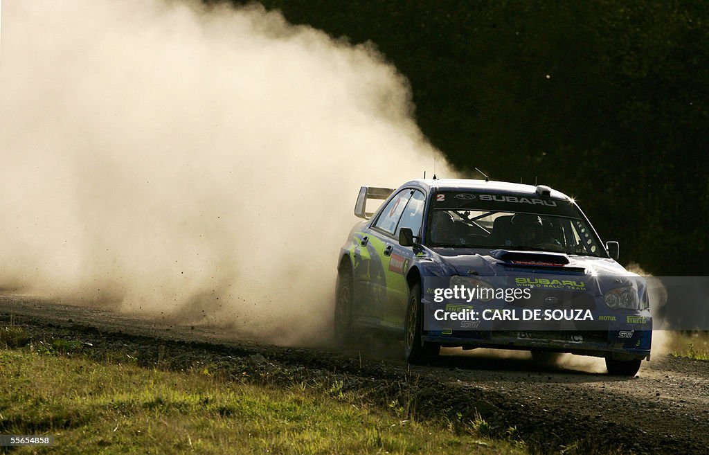 Australian Rally driver, Chris Atkinson of the Subaru team passes ...
