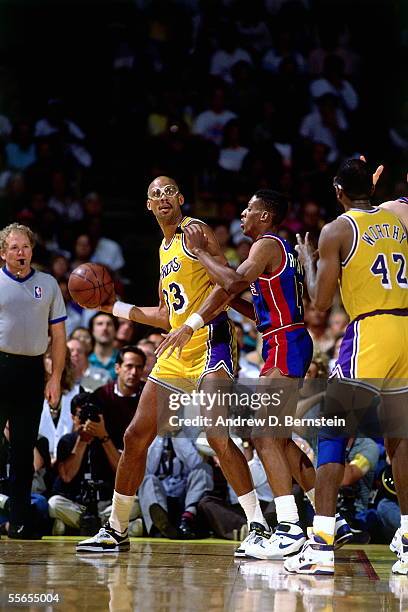 Kareem Abdul-Jabbar of the Los Angeles Lakers looks to pass out of the post against Dennis Rodman of the Detroit Pistons during Game four of the 1989...