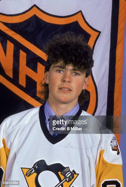 Czech professional hockey player Jaromir Jagr of the Pittsburgh Penguins poses in front of the National Hockey League logo wearing a shirt and tie...