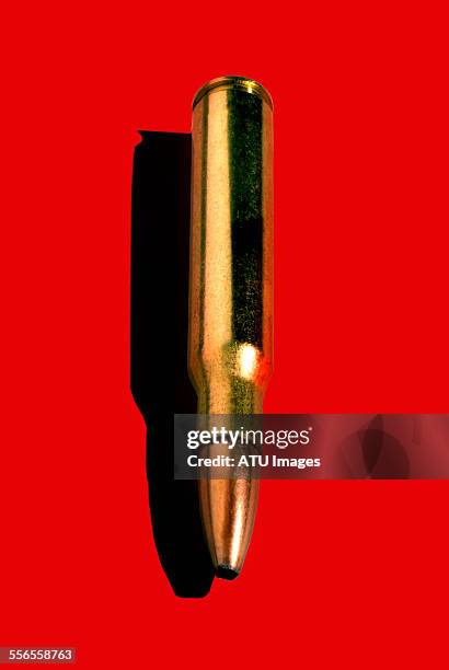 bullet on red - bullets stock pictures, royalty-free photos & images