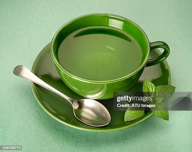 green tea on green background - grüner tee stock-fotos und bilder