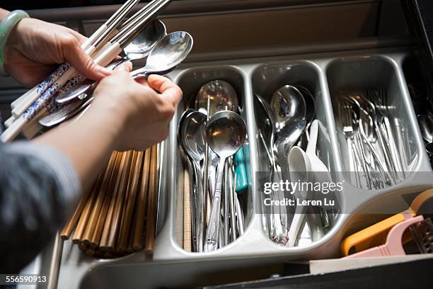 woman picking chopsticks and spoons - silverware stock pictures, royalty-free photos & images