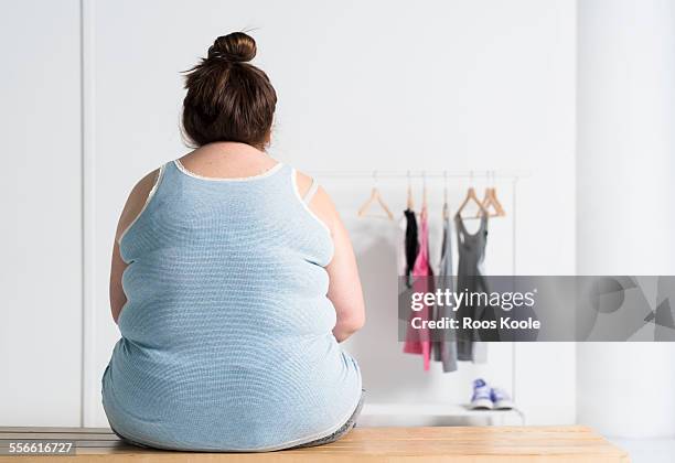 teenaged overweight girl sitting at a bench - chubby girl stock-fotos und bilder