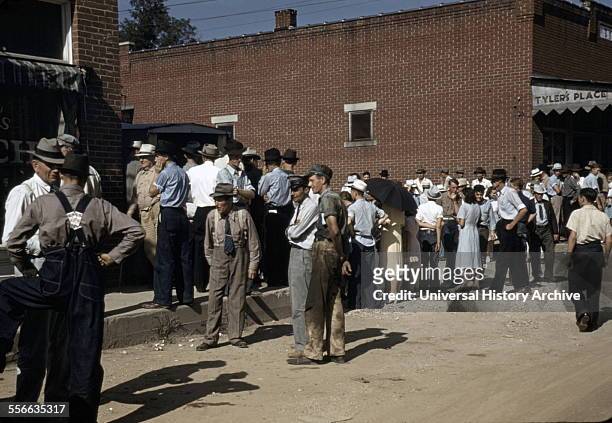 Farmers and townspeople in the centre of town on Court Day, Campton, Kentucky by photographer Marion Post, Wolcott . September 1940.