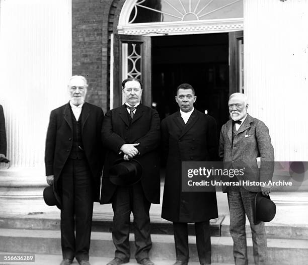 Robert C. Ogden, Senator William Howard Taft, Booker T. Washington and Andrew Carnegie, standing on the steps of a building, at the Tuskegee...