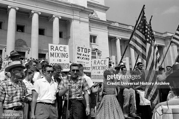 White segregationist demonstrators protesting at the admission of the Little Rock Nine, to Central High School, 1959. The Little Rock Nine were a group of nine African American students enrolled in Little Rock Central High School in 1957. Their enrol White segregationist demonstrators protesting at the admission of the Little Rock Nine, to Central High School, 1959. The Little Rock Nine were a group of nine African American students enrolled in Little Rock Central High School in 1957. Their enrol