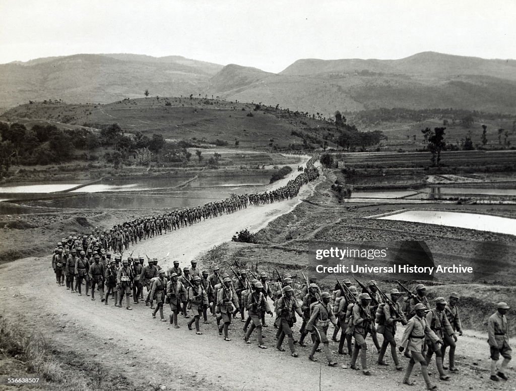 Photographic print of Chinese soldiers marching on road in Burma. Road heading toward the Salween front during the Burma Campaign in the South-East Asian Theatre of World War II. Dated 1943.