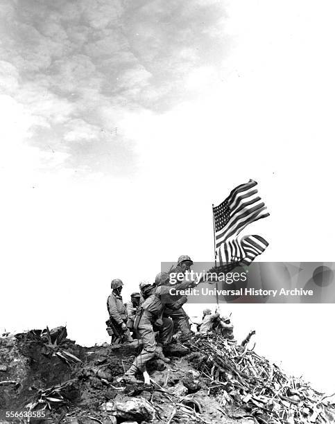 Flag raising on Iwo Jima. Installing large flag on Mt. Suribachi.