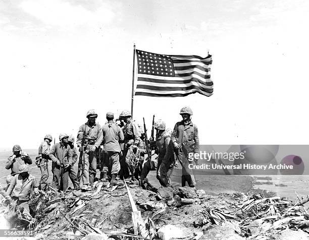 Battle of Iwo Jima. Photo taken during flag raising on volcano top.